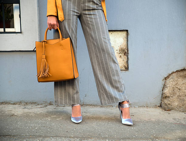 Elegant woman wearing high heels Woman wearing high heals and bag trousers stock pictures, royalty-free photos & images