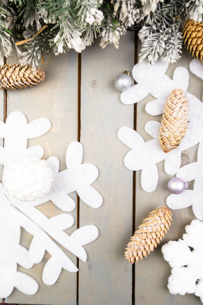 istock Decorative snowflake, Christmas tree and cone on wooden background. Christmas greeting card. Copy space. Top view. Flat lay. 873241498