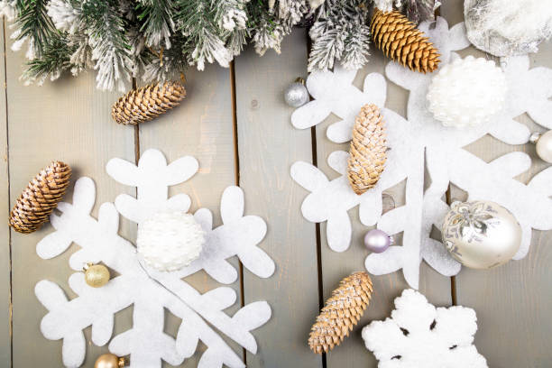 istock Decorative snowflake, Christmas tree and cone on wooden background. Christmas greeting card. Copy space. Top view. Flat lay. 873241502