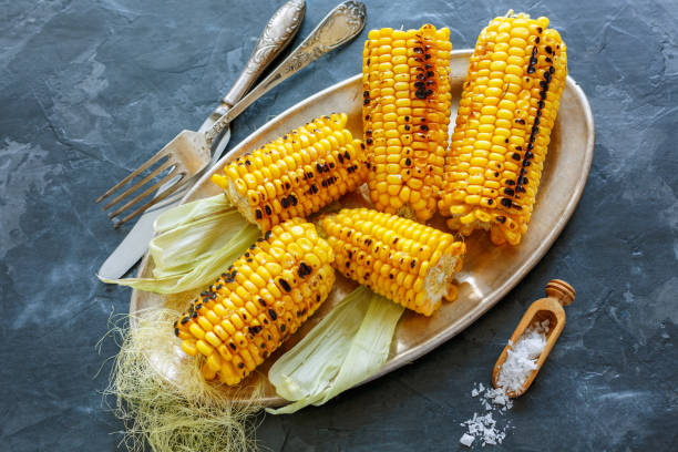 istock Corn grilled with sea salt on a metal tray. 873242336