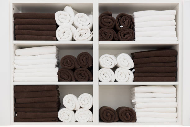 istock White and black towels rolled up on rolls on white shelf 873242622