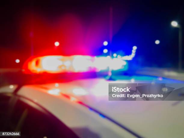 Red And Blue Lights Of Police Car In Night Time Night Patrolling The City Abstract Blurry Image Stock Photo - Download Image Now