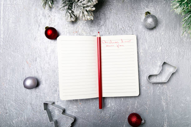 istock Christmas menu plan. Background for writing the Christmas menu. Top view. Notebook on grey background with decoration. 873245236