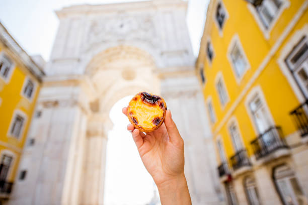 istock Holding pastel de Nata cake outdoors 873246280