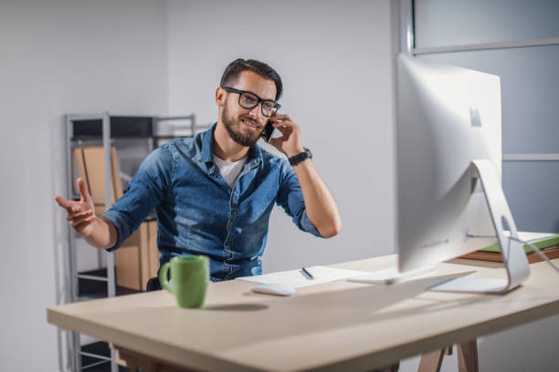 istock Talking on the phone at the office 873249234