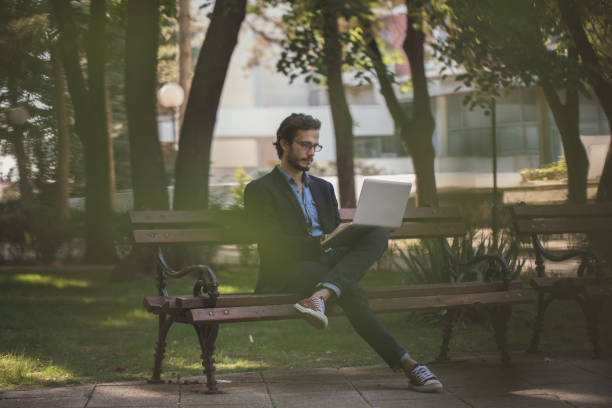 istock Businessman working in park 873249696