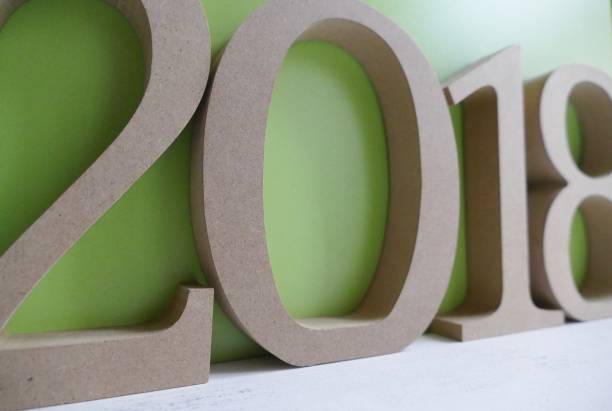 istock Numbers  2018 on green wooden wall , new year 873250006