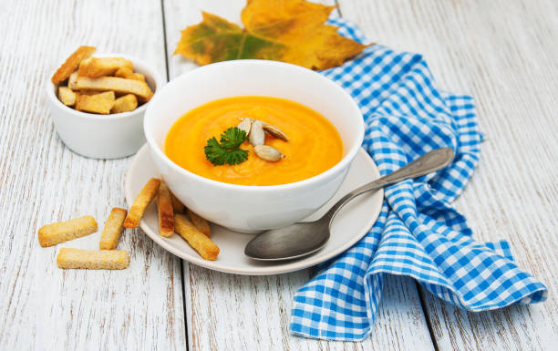 istock Pumpkin soup with fresh pumpkins 873252948