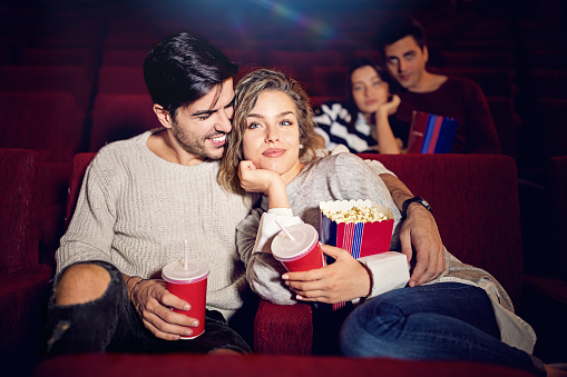 Couple is watching romantic movie in the cinema theater