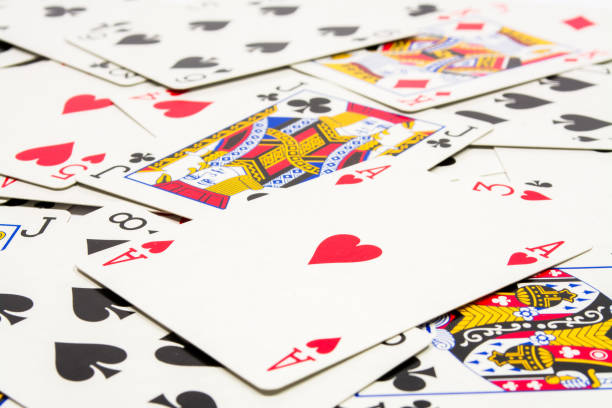 istock playing cards scattered on the table, background 873253260
