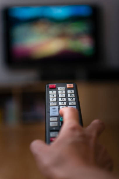 istock woman with television remote control changing channels 873256508