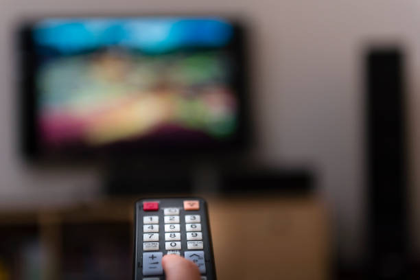 istock woman with television remote control changing channels 873256526