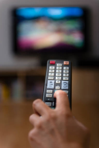 istock woman with television remote control changing channels 873256568