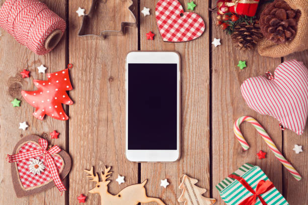 istock Smart phone mock up with rustic Christmas decorations for app presentation. View from above 873256570