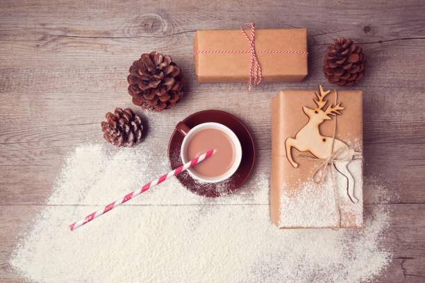 istock Christmas creative still life with handmade gift boxes with cup of chocolate. View from above 873256630