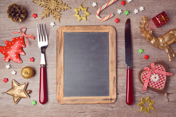 istock Christmas menu background with chalkboard and decorations. View from above 873256650