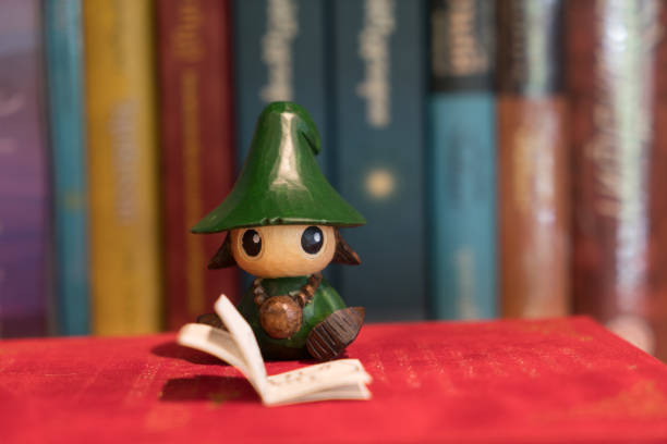 front view of reading doll in book shelf