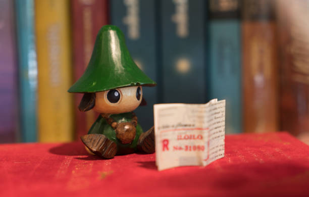 istock Reading green kid figure reading books in book shelf 873261262
