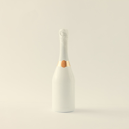 Minimalistic white champagne bottle on white background. Party concept.