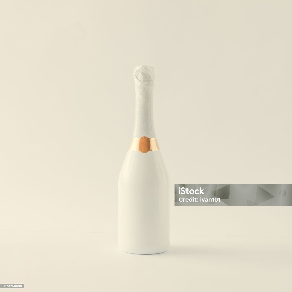 Minimalistic white champagne bottle on white background. Party concept. Champagne Stock Photo