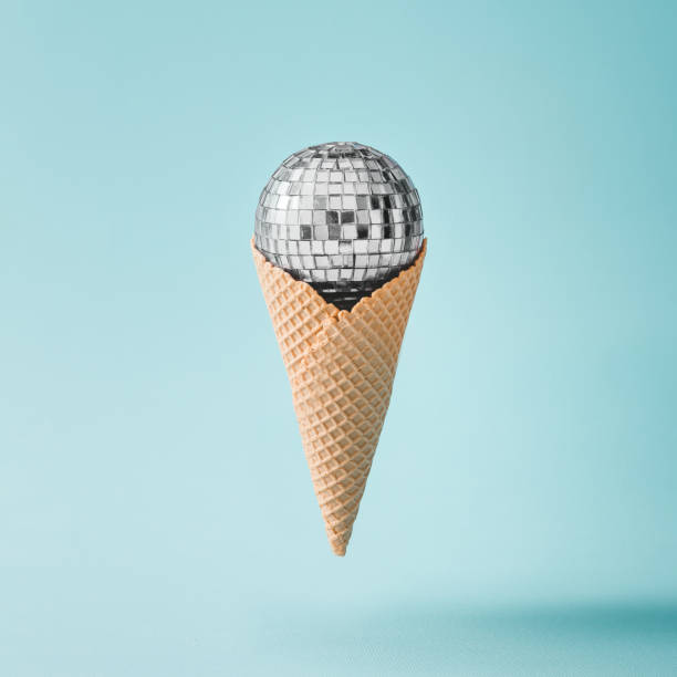 Disco ball ice cream on bright blue background. Minimal party concept.