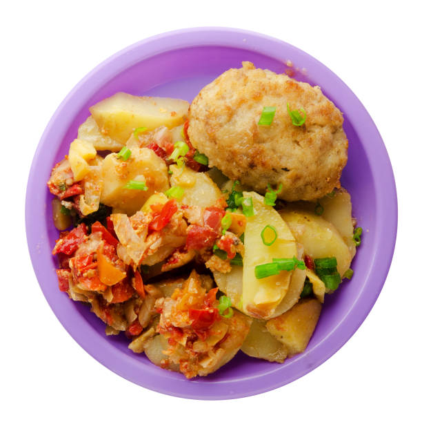 istock Cutlets with potatoes and stewed tomatoes. 873264842