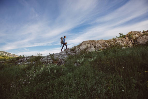 istock Hiker climbing on the rocks 873270406