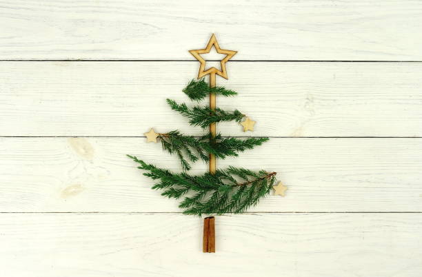 istock Christmas tree made of thuja branches and decorations om white wooden background 873275358