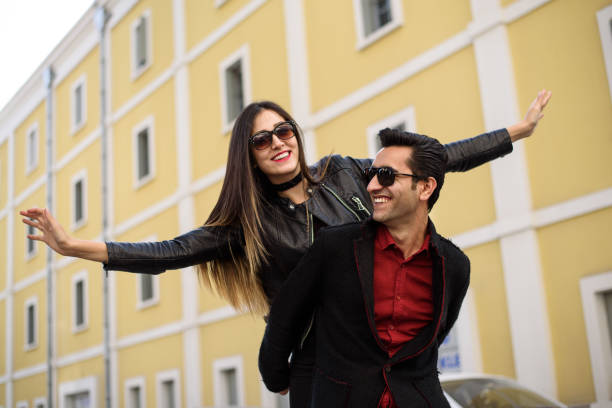 istock Young man piggyback her girlfriend 873275398