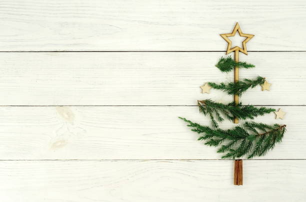 istock Christmas tree made of thuja branches and decorations om white wooden background 873276832