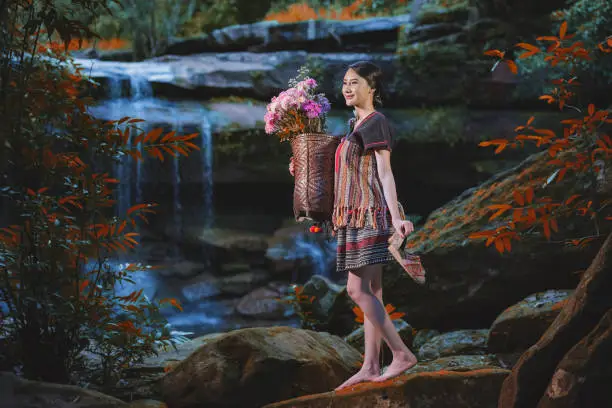 tribes at waterfall in the forest,tribe in beautiful costume dress at beautiful waterfall.