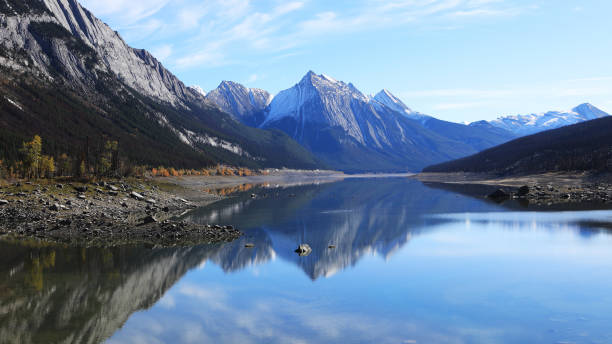 istock Reflections on a tranquil lake view in the Rocky Mountains 873279174