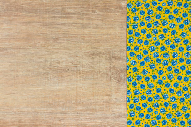 Pattern flower cloth napkin on empty wooden background.