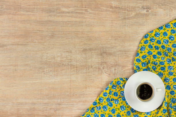 istock Coffee on pattern flower cloth napkin on empty wooden background. 873286676