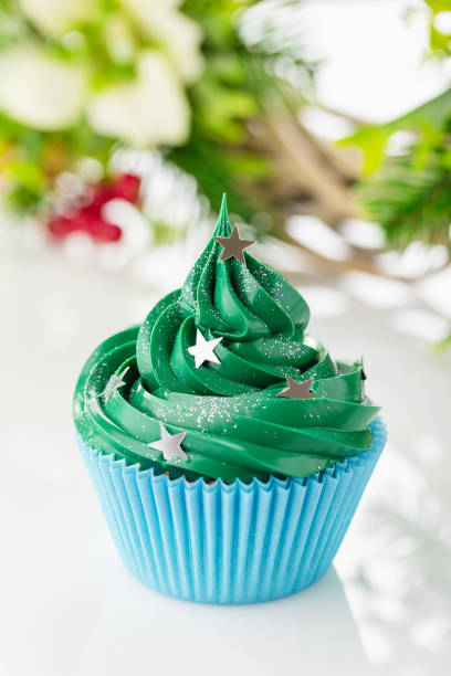 istock Green christmas cupcake with festive decorations 873286940