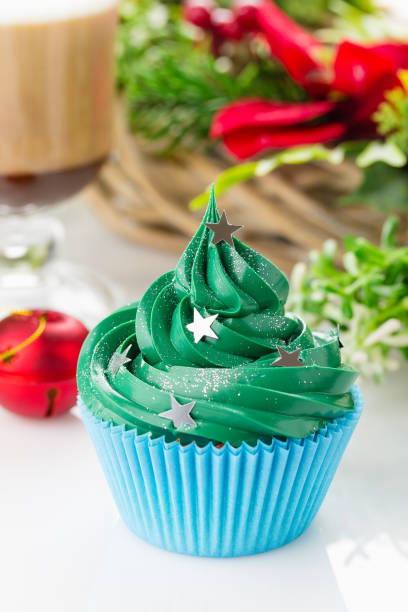 istock Green christmas cupcake with festive decorations 873286962