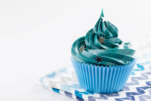 Blue cupcake with stars glitter sprinkles stock photo