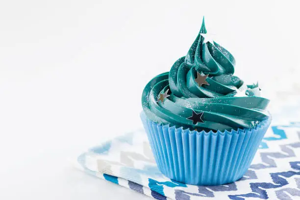 Photo of Blue cupcake with stars glitter sprinkles