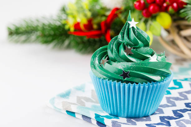 istock Green christmas cupcake with festive decorations 873286986