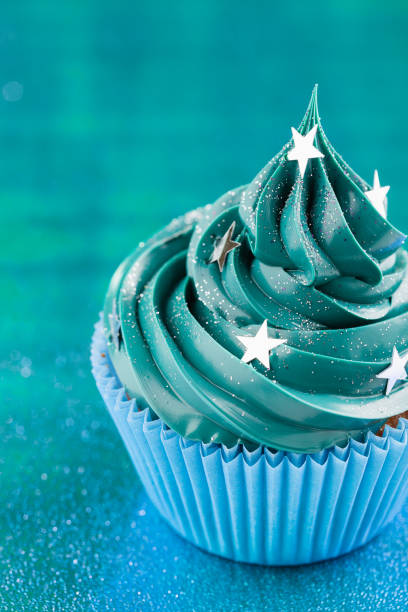 istock Blue cupcake with stars glitter sprinkles 873286994