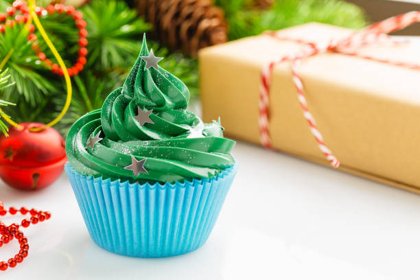 istock Green christmas cupcake with festive decorations 873287052