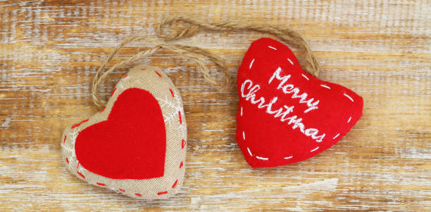 istock Merry Christmas card with canvas hearts on wooden surface 873311632