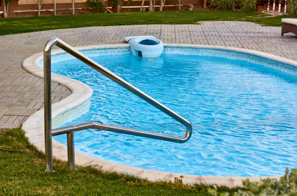 istock Swimming pool with metal stair. Blue water 873314510