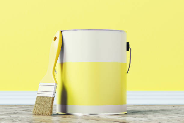 istock Yellow paint bucket and a brush 873315934