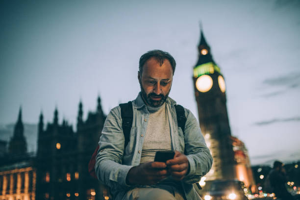 istock Senior man with a backpack and a mobile phone 873316606