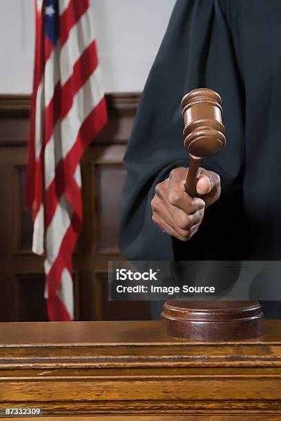 A Judge Holding A Gavel Stock Photo - Download Image Now - Gavel, Judge - Law, Courtroom