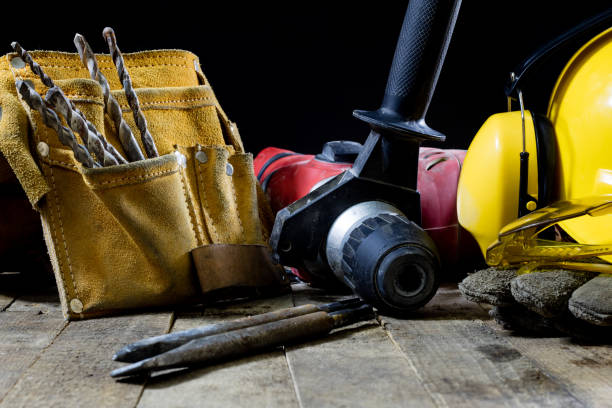 istock Safety accessories and impact hammer. Accessories for a builder on a wooden table. Black background. 873328240