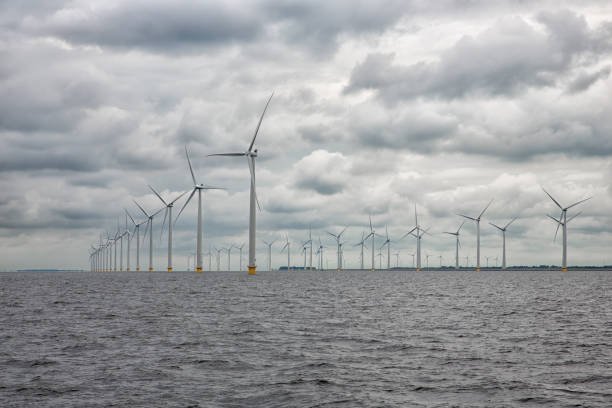 istock Offshore windfarm near Dutch coast with cloudy sky 873330762