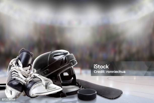 Ice Hockey Helmet Skates Stick And Puck In Rink Stock Photo - Download Image Now - Ice Hockey, Hockey, Ice Skate