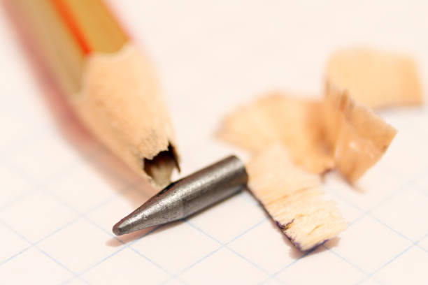 istock Sharpened pencil with a broken tip over a blank sheet of paper 873331630